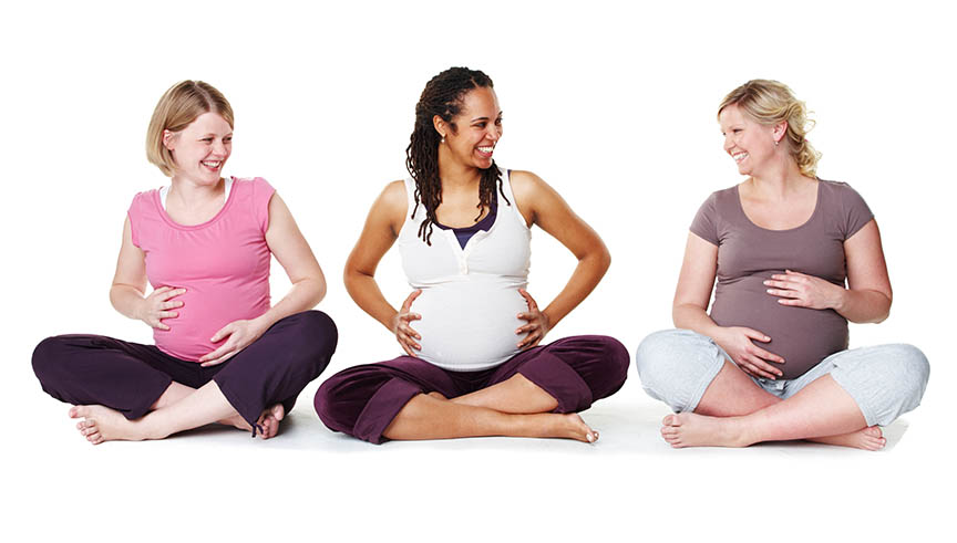 Group of sitting, pregnant mothers.